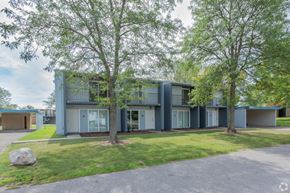 Twinsburg apartment for rent - the exterior of a blue house with trees in front of it
