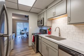 Twinsburg apartment for rent - redesigned kitchen with white cabinets and stainless steel appliances at the preserve at great neck apartments