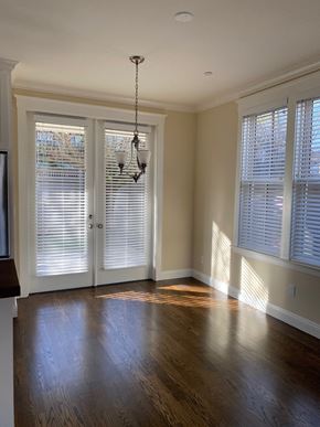 Sonoma house for rent - A room with a wooden floor and a chandelier.