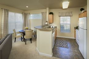 Thornton apartment for rent - A kitchen with a table and chairs in front of a window.
