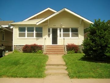 Kearney apartment for rent - a yellow house with stairs in front of it