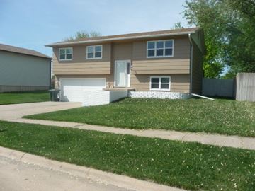 Kearney apartment for rent - a brown house with a lawn in front of it