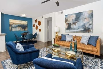 Grapevine apartment for rent - A living room with blue chairs and a brown couch.