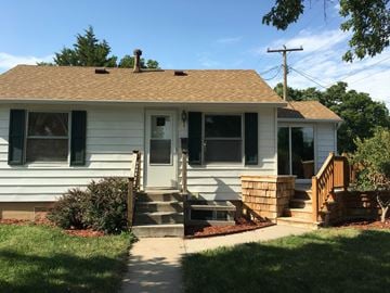 Kearney apartment for rent - a white house with a porch and stairs