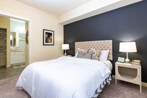 Redmond apartment for rent - A bedroom with a white bed and a picture on the wall.