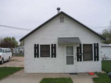 Kearney apartment for rent - a white house with black shutters and a white van