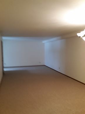 Sussex apartment for rent - A room with a white wall and a brown carpet.