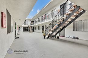Hawthorne apartment for rent - a building with a staircase and a blue sky in the background