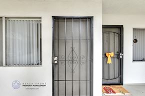 Hawthorne apartment for rent - a front door with a yellow ribbon and a window with a curtain