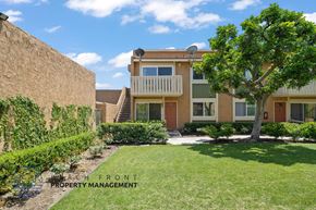 Buena Park apartment for rent - A tree in a yard in front of a building.