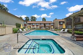Buena Park apartment for rent - A swimming pool with a logo of Beachfront Property Management.