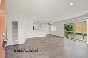 Buena Park apartment for rent - A spacious room with wooden flooring and a ceiling fan is available for rent.