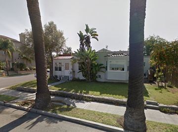 Huntington Beach apartment for rent - a house on a street with palm trees