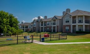 Oklahoma City apartment for rent - A large, well-maintained apartment complex with a playground in the foreground.
