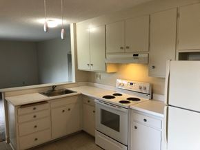 Santa Cruz apartment for rent - a kitchen with white cabinets and a stove and a refrigerator