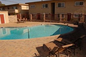 Westminster apartment for rent - A pool surrounded by chairs and a fence.