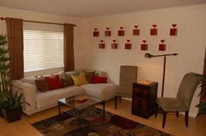 Westminster apartment for rent - A living room with a white couch, a coffee table, a lamp, and a plant.