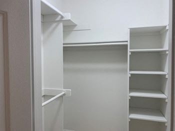 Multiple walk-in closets with built-in shelves*