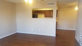 Goodyear apartment for rent - an empty living room with white walls and wood floors