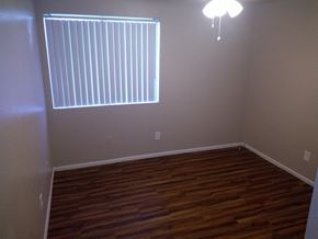 Goodyear apartment for rent - a empty room with wood floors and a window