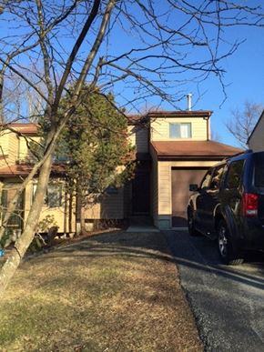Highland house for rent - A black truck is parked on a driveway in front of a house.
