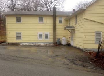 Westtown apartment for rent - the outside of a yellow house with a parking lot