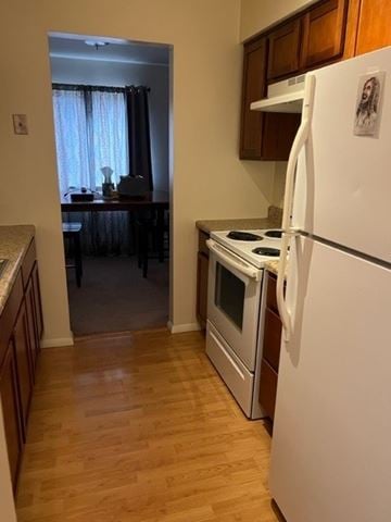 Arlington apartment for rent - A white refrigerator with a magnet on it is in a kitchen.
