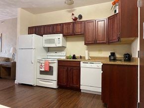 O'fallon apartment for rent - a kitchen with white appliances and wooden cabinets