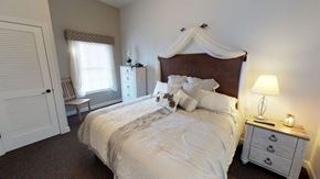 O'fallon apartment for rent - a bedroom with a bed and a dresser and a window