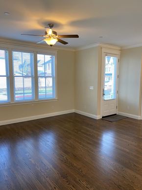 Sonoma house for rent - an empty living room with wooden floors and a ceiling fan