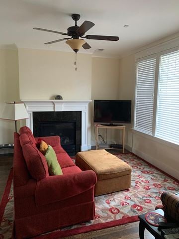 Sonoma house for rent - a living room with a red couch and a ceiling fan