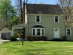 Arlington house for rent - a yellow house with a lawn and a white door