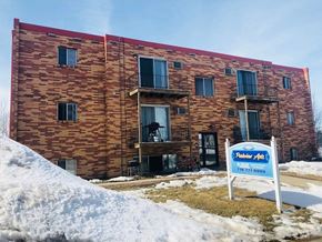 Moorhead apartment for rent - A building with a sign in front that says "Faber Apartments" and a phone number.