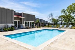 Lawrence apartment for rent - Apartments for Rent in Lawrence - Fairway Flats - Pool Area with Lounge Chairs and Views of Lush Greenery