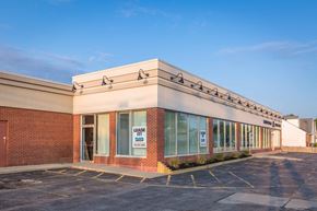 Tonawanda apartment for rent - A building with a "LEASE IT" sign on the window.