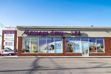 Tonawanda apartment for rent - A Massage Envy Spa with a purple sign and a white car parked in front.