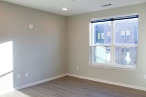 Spartanburg apartment for rent - a bedroom with a large window and wooden floors