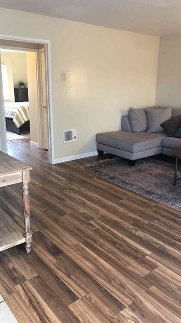 San Luis Obispo apartment for rent - A living room with a grey couch and a wooden floor.