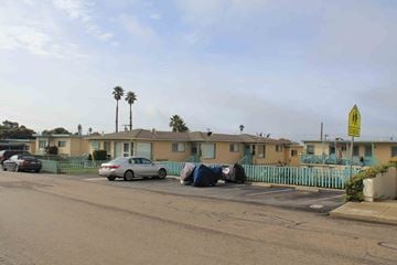 Morro Bay apartment for rent - A street view of a residential area with cars parked on the side of the road.