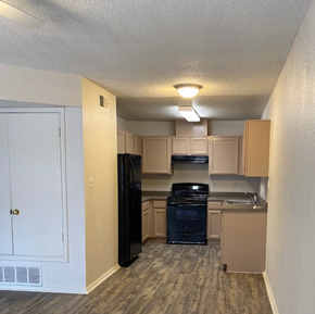 El Paso apartment for rent - A kitchen with a black refrigerator, stove, and oven.