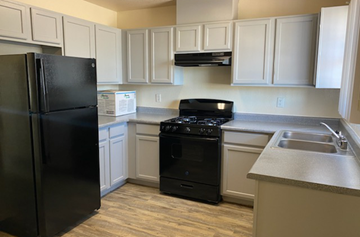 El Paso apartment for rent - a kitchen with black appliances and white cabinets