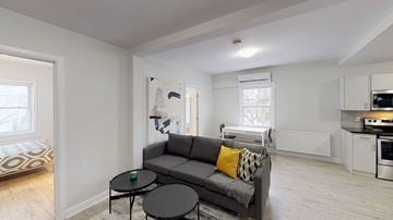 Ottawa apartment for rent - A living room with a grey couch and a black coffee table.