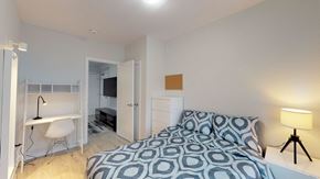 Ottawa apartment for rent - A bedroom with a bed, desk, and chair.