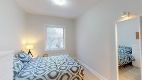 Ottawa apartment for rent - A bedroom with a bed and a window.