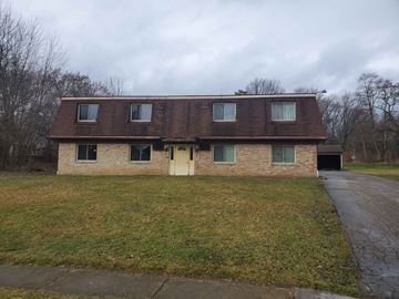 Youngstown apartment for rent - the front of a brick house with a yellow door
