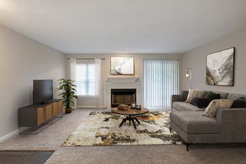 Nashville apartment for rent - a living room with a fireplace and a couch and a tv
