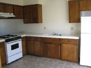 Grover Beach apartment for rent - A white stove and oven in a kitchen with wooden cabinets.