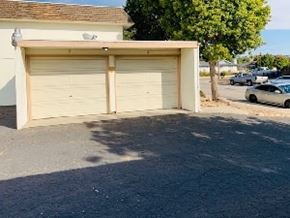 Grover Beach apartment for rent - A garage door is closed and the garage door opener is on the top of the garage.