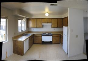 Arroyo Grande apartment for rent - A kitchen with wooden cabinets and white appliances.