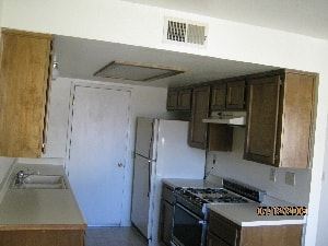 Grover Beach apartment for rent - A kitchen with a stove and a refrigerator.